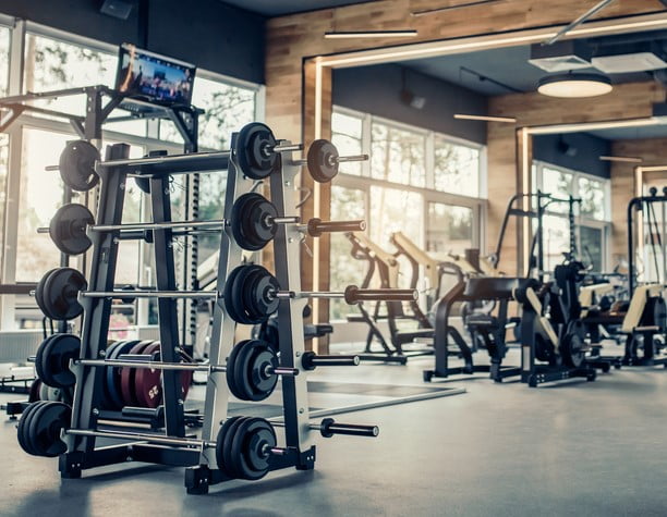 stock photo modern light gym sports equipment in gym barbells of different weight on rack 721723381